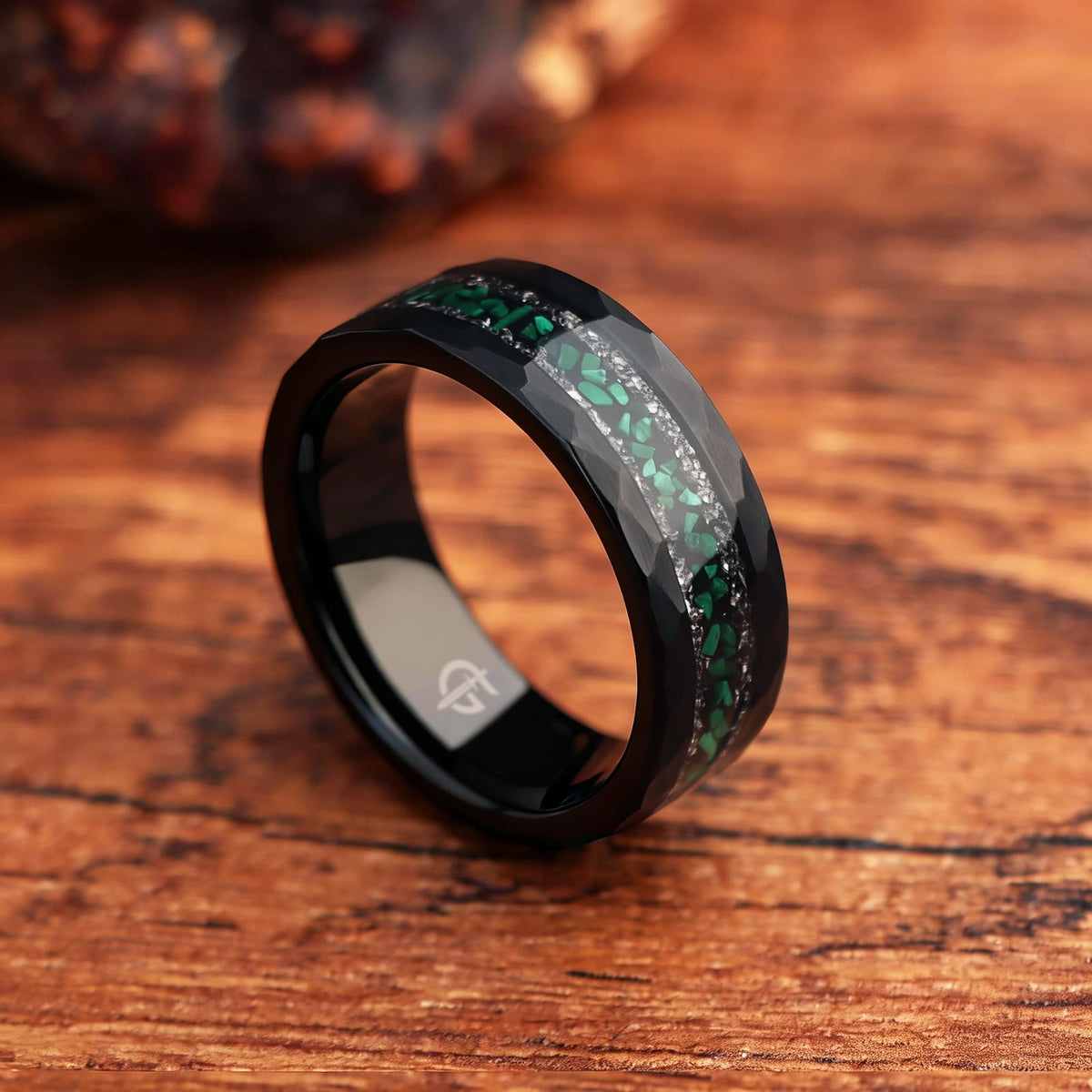 Hammered black tungsten ring with green malachite centered between two rows of silver-gray meteorite fragments
