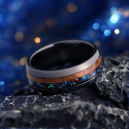 Polished black ceramic ring with brown wood beside blue-green, red and silver-gray inlay fragments.