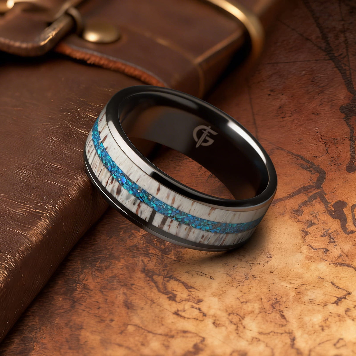 Black ceramic ring with pale deer antler framing blue natural opal and silver-gray meteorite fragments