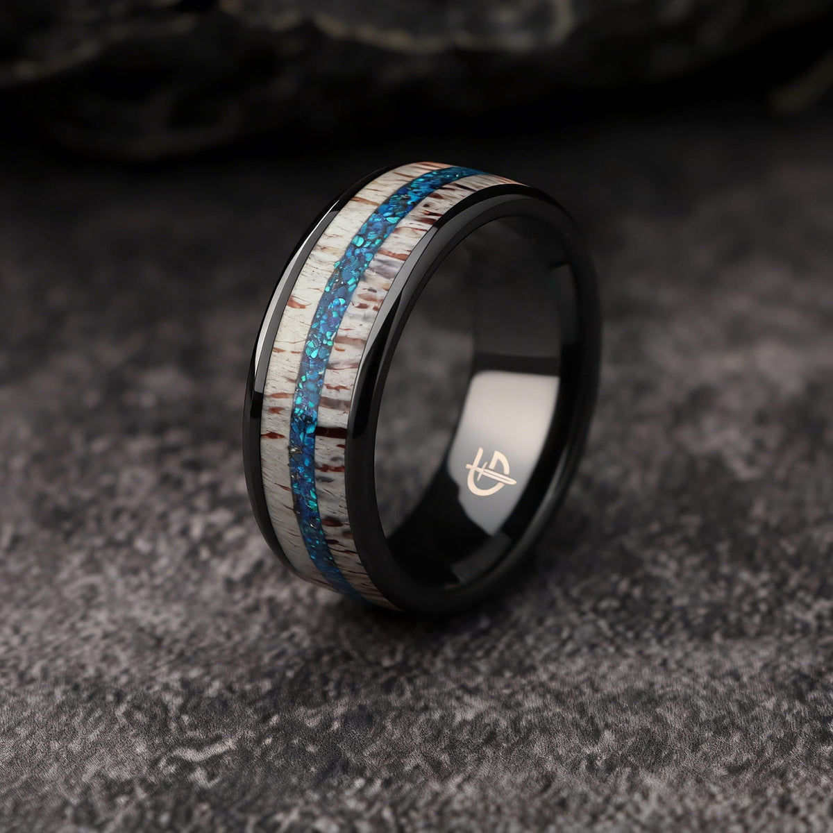Black ceramic ring with pale deer antler framing blue natural opal and silver-gray meteorite fragments