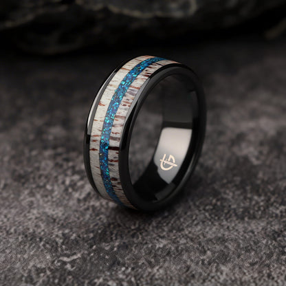 Black ceramic ring with pale deer antler framing blue natural opal and silver-gray meteorite fragments