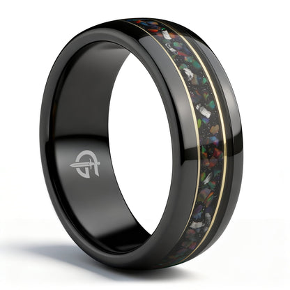 Polished black ceramic ring with multicolored natural opal and silver-gray meteorite fragments framed by two thin brass lines.