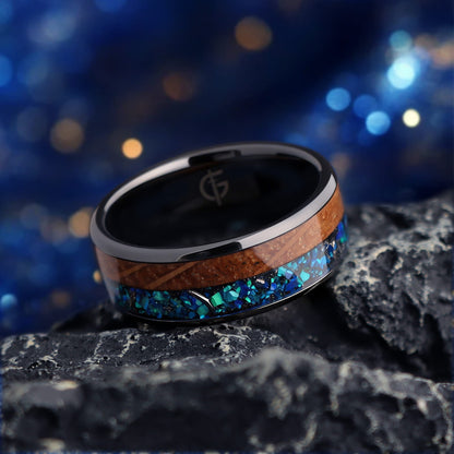 Flat black ceramic ring with brown whiskey barrel wood beside blue natural opal and silver-gray meteorite
