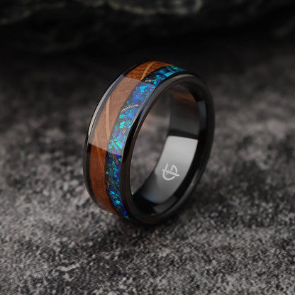 Flat black ceramic ring with brown whiskey barrel wood beside blue natural opal and silver-gray meteorite