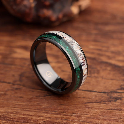 Rounded black ceramic ring with separate green malachite and pale, brown-marked deer antler inlays