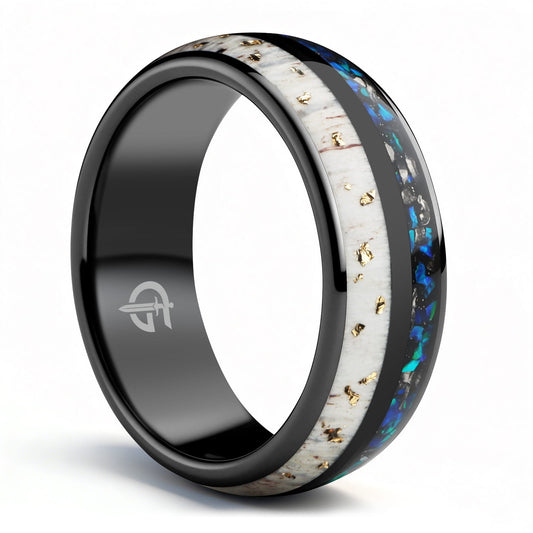 Black ceramic ring with gold-flecked antler beside Sleepy Blue natural opal and meteorite fragments