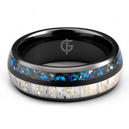 Black ceramic ring with gold-flecked antler beside Sleepy Blue natural opal and meteorite fragments