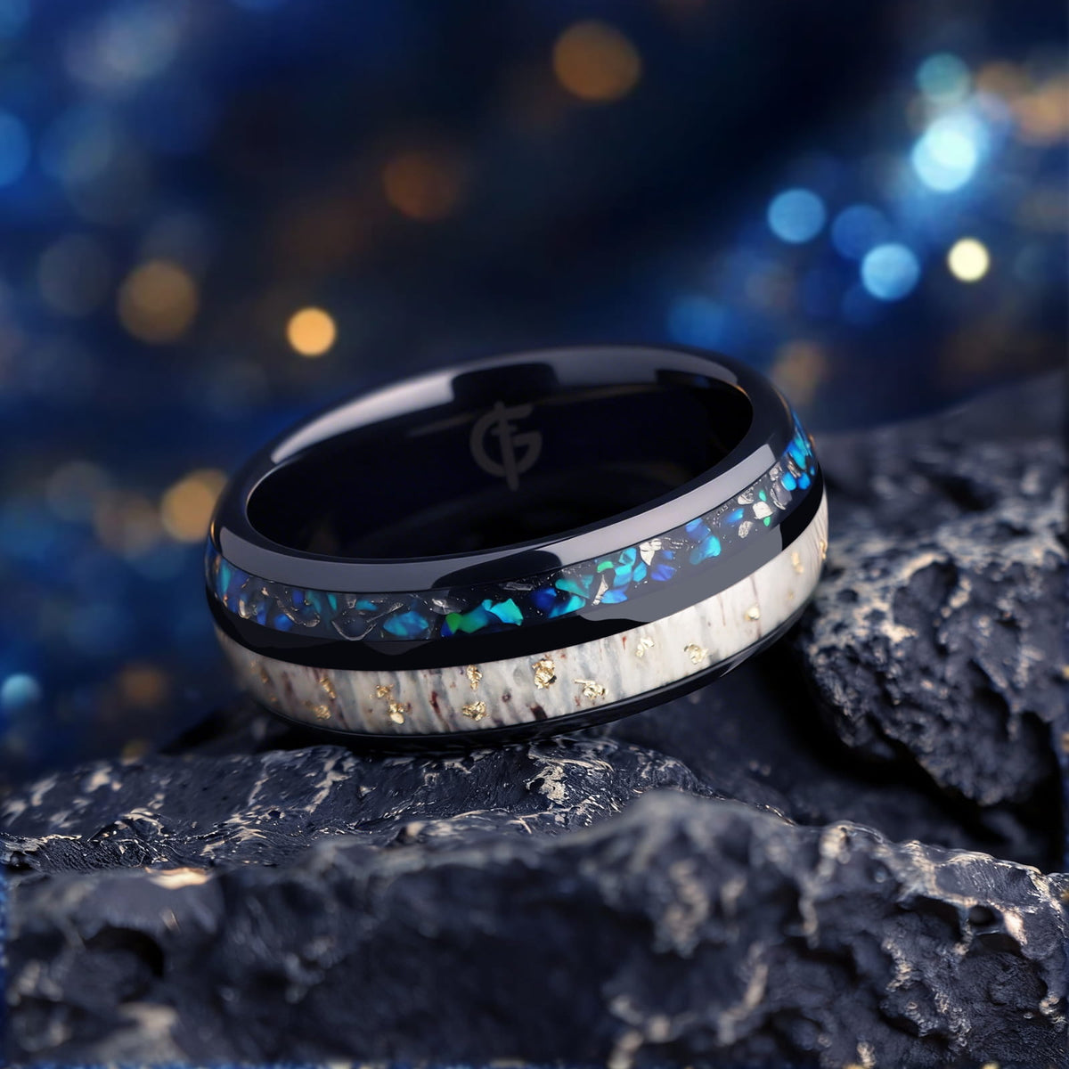 Black ceramic ring with gold-flecked antler beside Sleepy Blue natural opal and meteorite fragments