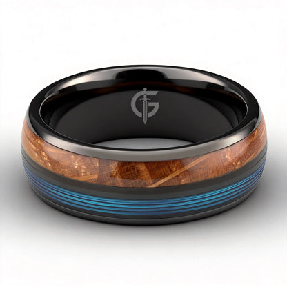 Black ceramic ring with brown whiskey barrel wood and blue fishing line inlays separated by a black strip.
