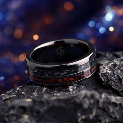 Flat black ceramic ring with red agate and dinosaur bone beside silver-gray meteorite and black agate