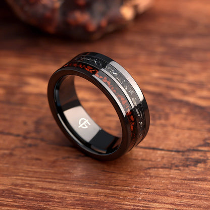 Flat black ceramic ring with red agate and dinosaur bone beside silver-gray meteorite and black agate
