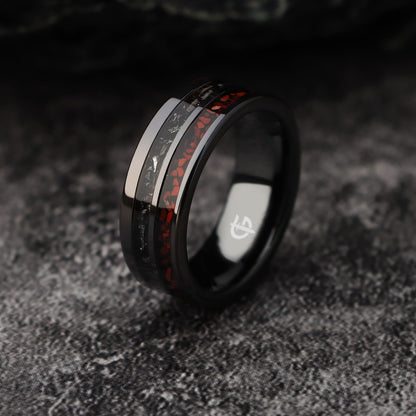 Flat black ceramic ring with red agate and dinosaur bone beside silver-gray meteorite and black agate