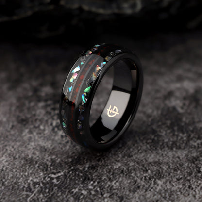 Black ceramic ring with red dinosaur bone center between two iridescent abalone shell and silver-gray meteorite bands.