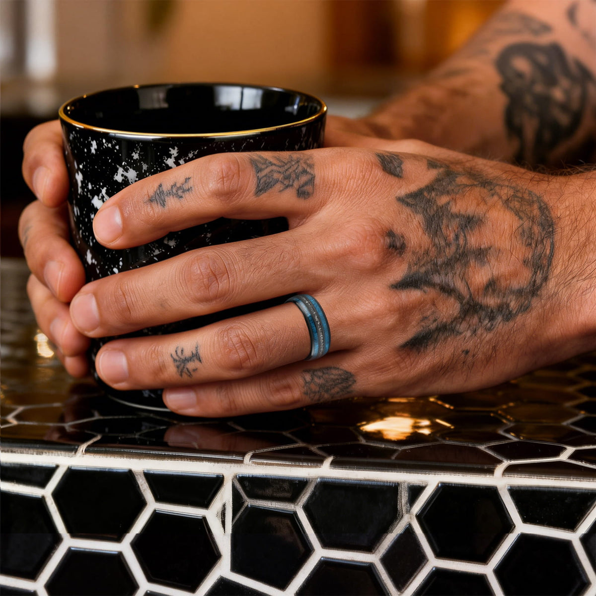 Polished black ceramic ring with two blue whiskey barrel wood bands framing silver-gray Gibeon meteorite fragments.