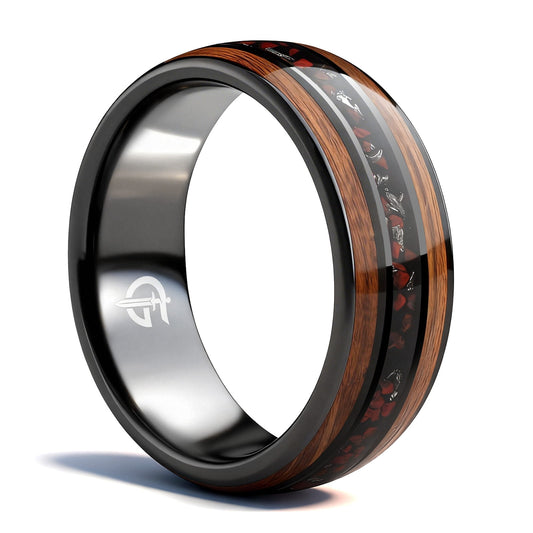 Black ceramic ring with brown wood strips framing silver-gray meteorite and reddish dinosaur bone fragments