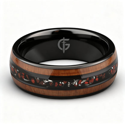 Black ceramic ring with brown wood strips framing silver-gray meteorite and reddish dinosaur bone fragments