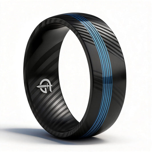 Black Damascus steel ring with diagonal gray markings and a narrow blue fishing line inlay.