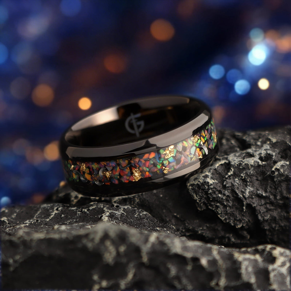 Black titanium ring with multicolored natural opal, silvery meteorite fragments, gold leaf and beveled edges