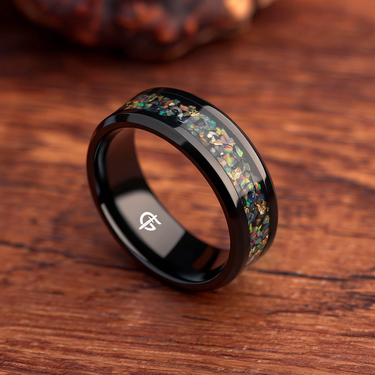 Black titanium ring with multicolored natural opal, silvery meteorite fragments, gold leaf and beveled edges