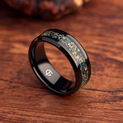 Black titanium ring with multicolored natural opal, silvery meteorite fragments, gold leaf and beveled edges