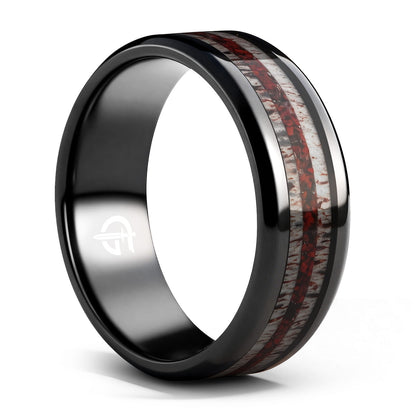 Black titanium ring with pale deer antler bands flanking a reddish mixed inlay and beveled edges