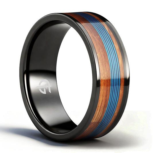 Black titanium ring with blue fishing line centered between brown whiskey barrel wood bands