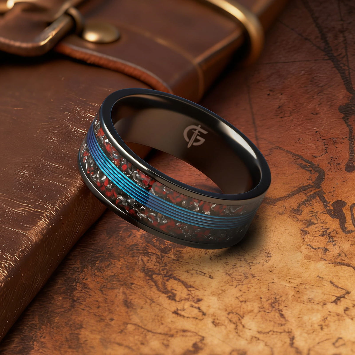 Black titanium ring with blue fishing line centered between mixed red and silver-gray inlay fragments