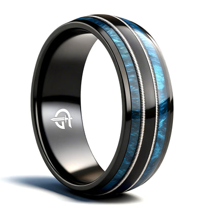 Black titanium ring with blue whiskey barrel wood and silver-tone guitar strings in two mirrored channels