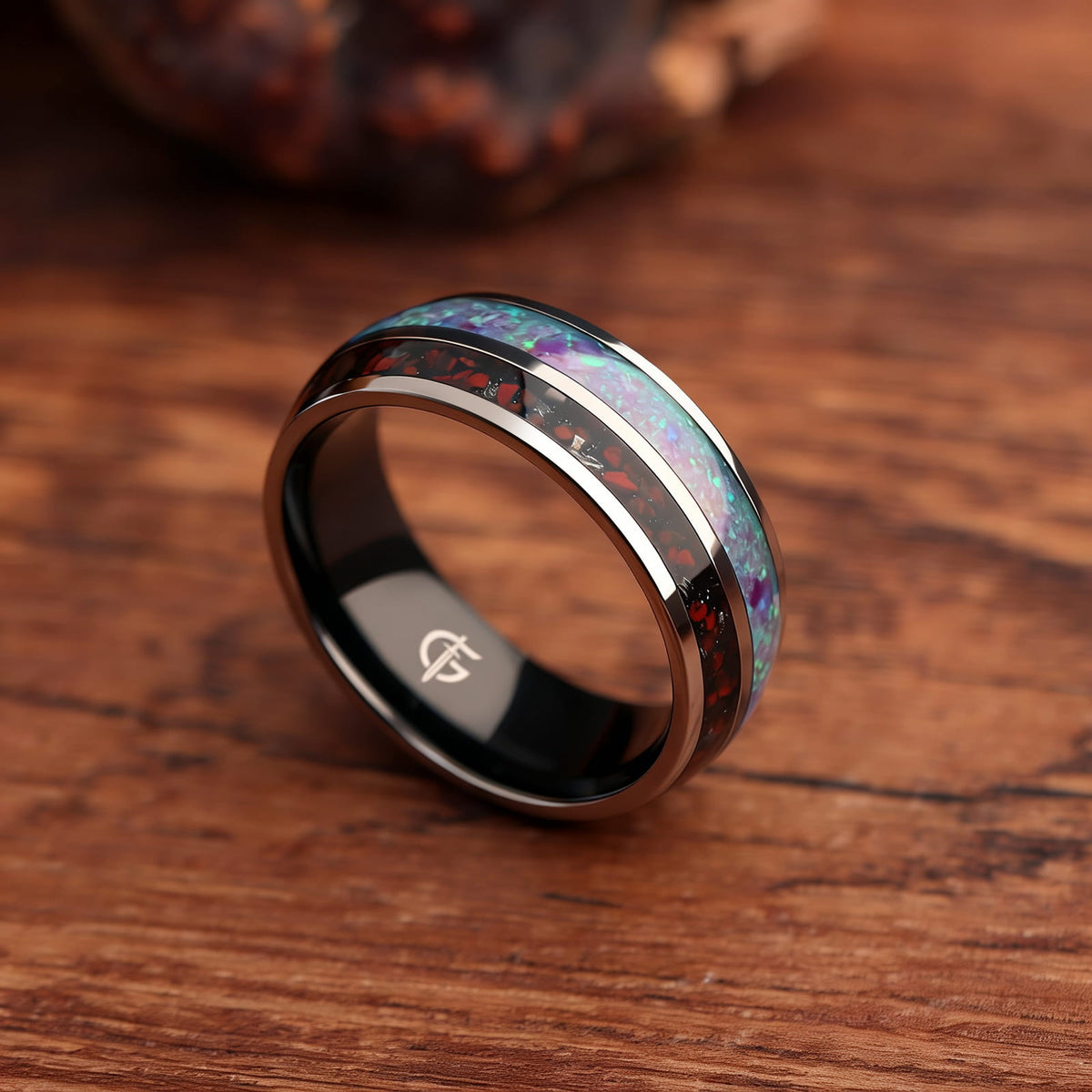Titanium ring with black interior, lavender-green natural opal and a separate red-and-gray meteorite and dinosaur bone inlay