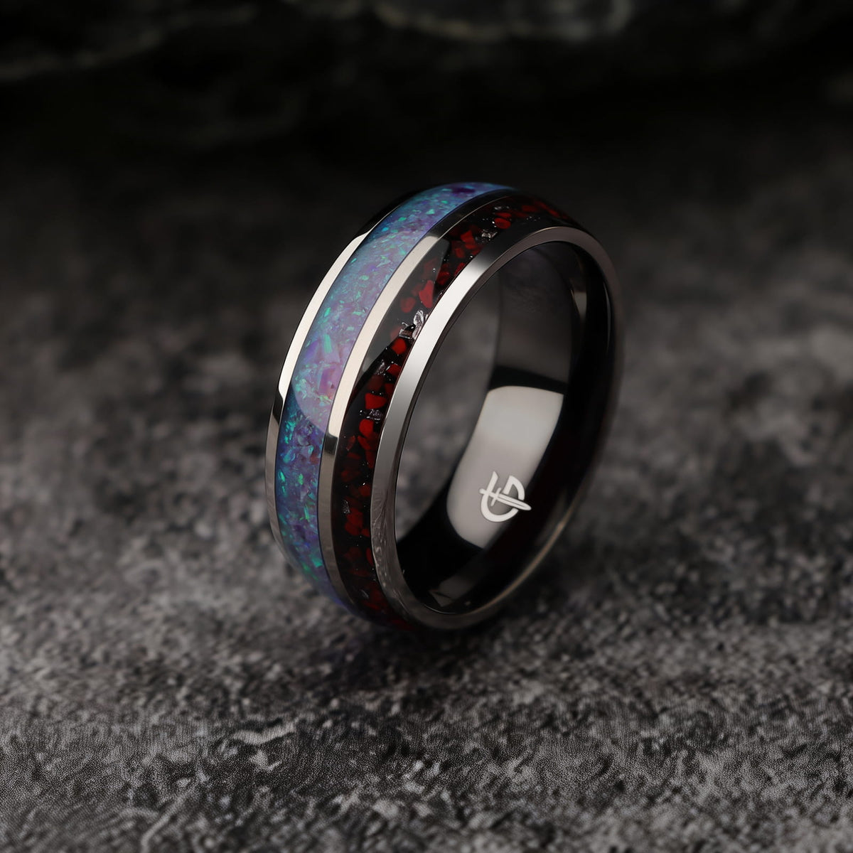 Titanium ring with black interior, lavender-green natural opal and a separate red-and-gray meteorite and dinosaur bone inlay