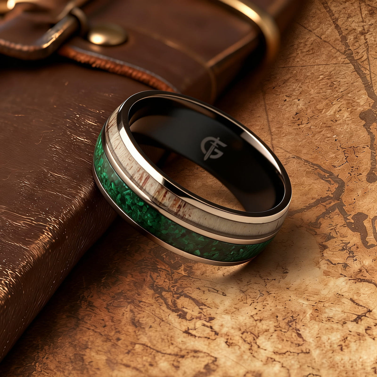 Titanium ring with black interior, green malachite and pale deer antler in separate inlay channels