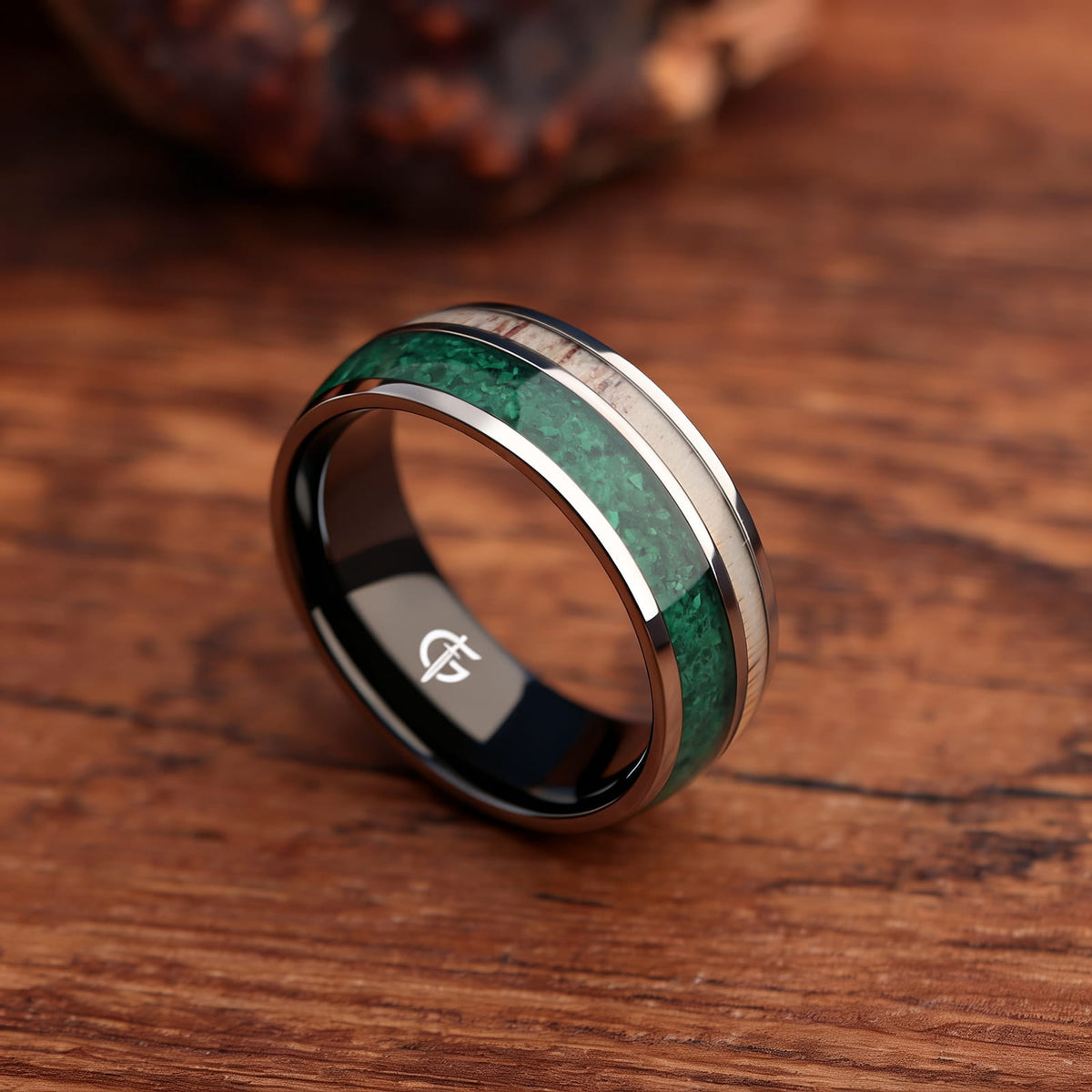 Titanium ring with black interior, green malachite and pale deer antler in separate inlay channels