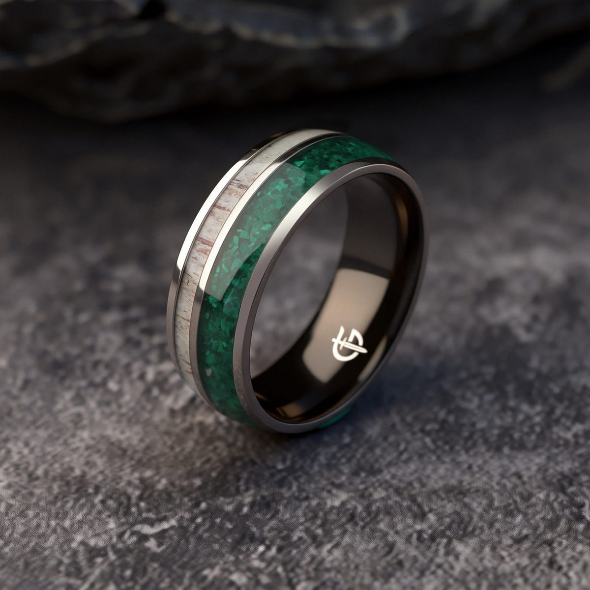 Titanium ring with black interior, green malachite and pale deer antler in separate inlay channels