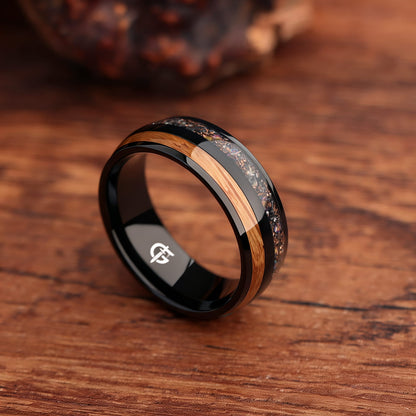 Black titanium ring with whiskey barrel wood beside a silver-gray meteorite, moonstone and copper inlay.