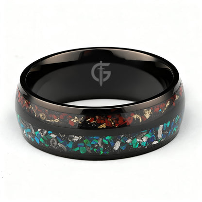 Black titanium ring with two inlays: blue-green opal and meteorite beside reddish-brown bone and copper.