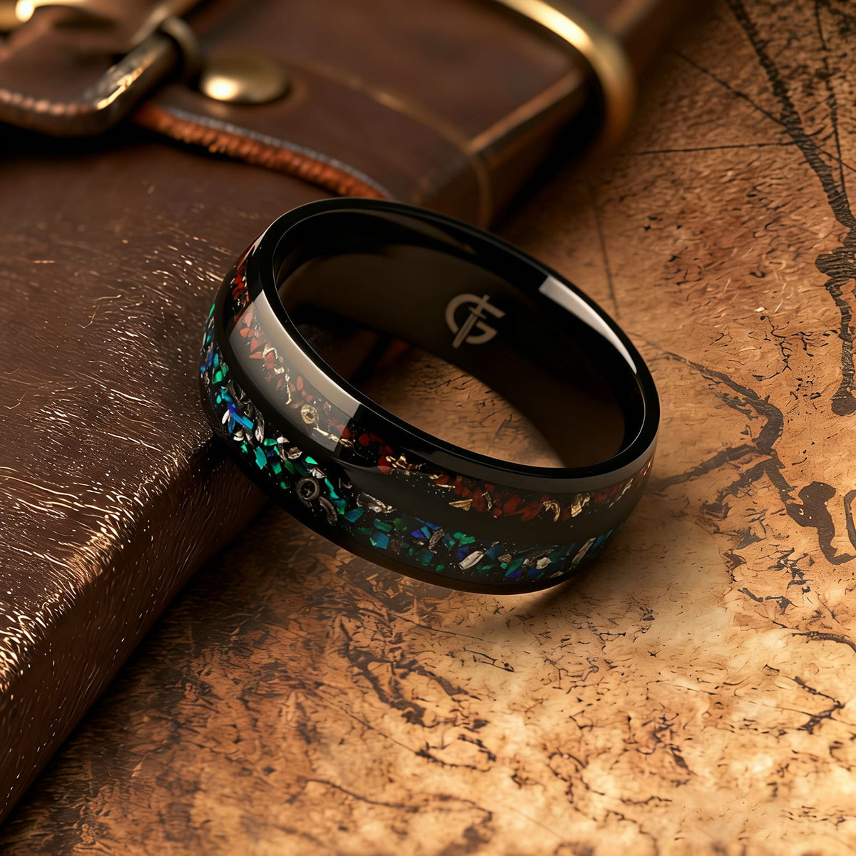 Black titanium ring with two inlays: blue-green opal and meteorite beside reddish-brown bone and copper.