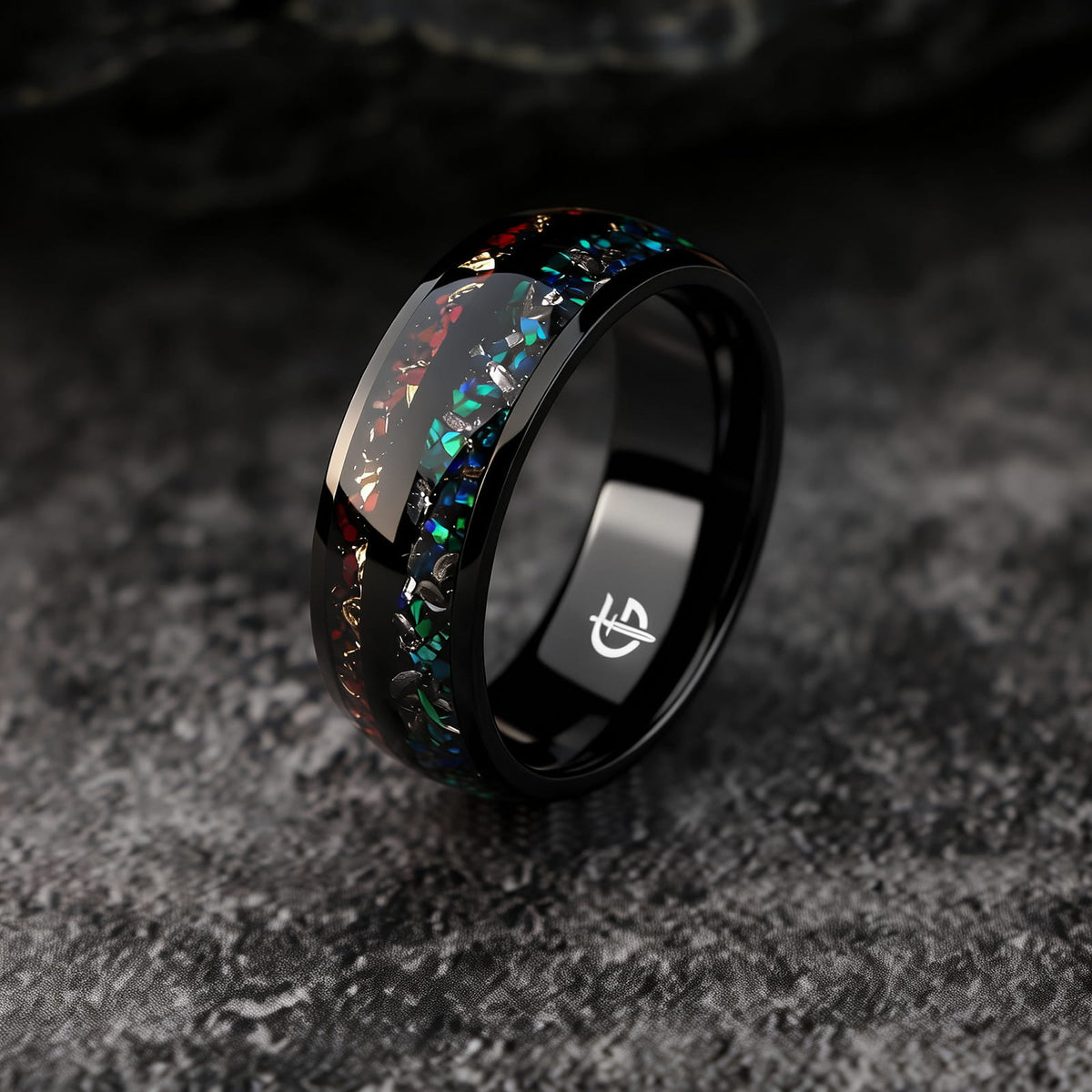 Black titanium ring with two inlays: blue-green opal and meteorite beside reddish-brown bone and copper.