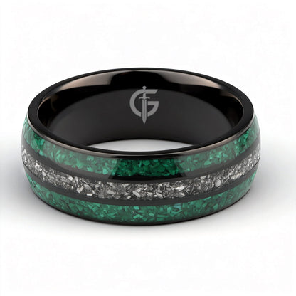 Polished black titanium ring with green malachite channels on either side of silver-gray meteorite.