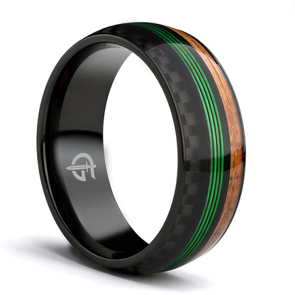 Black titanium ring with green fishing line between brown whiskey barrel wood and black carbon fiber