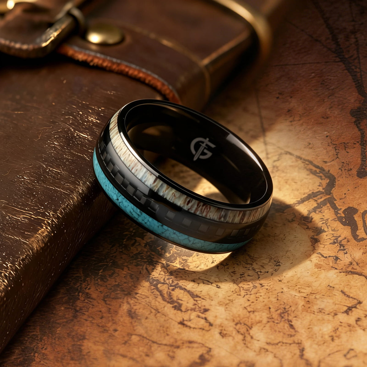 Black titanium ring with pale deer antler and blue turquoise flanking a black carbon fiber center