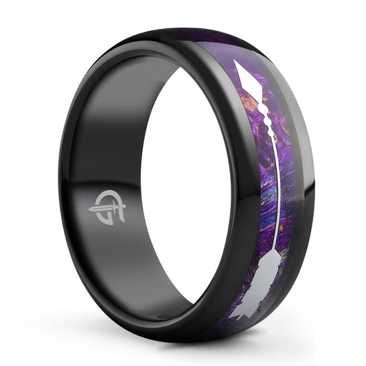 Polished black tungsten carbide ring with a silver-tone metal arrow over Starry Blue Whiskey Barrel Wood.