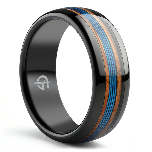 Polished black tungsten ring with blue fishing line between two strips of brown whiskey barrel wood