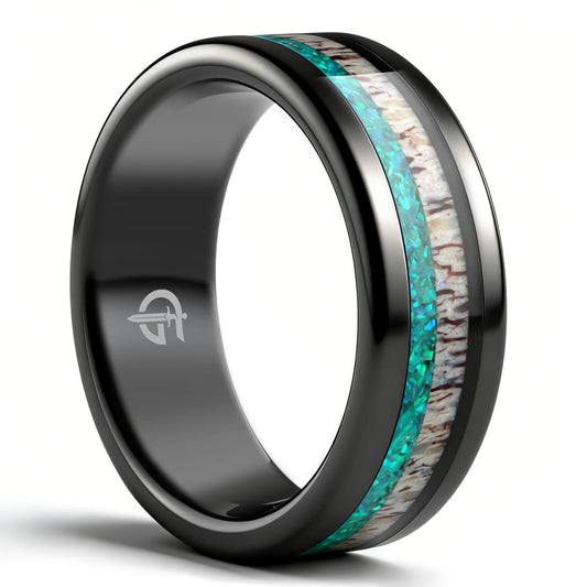 Polished black tungsten ring with pale deer antler beside blue-green natural opal