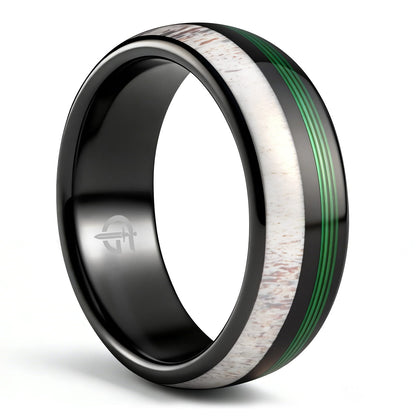 Polished black tungsten ring with pale deer antler beside parallel green fishing line strands