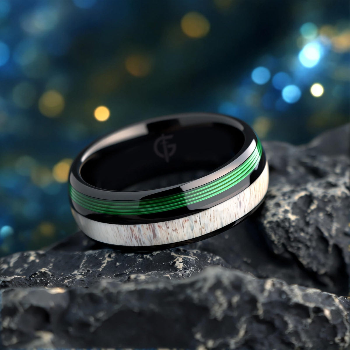 Polished black tungsten ring with pale deer antler beside parallel green fishing line strands