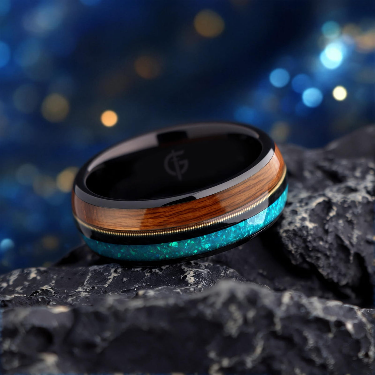 Black tungsten ring with brown whiskey barrel wood, gold-colored guitar string and blue opal inlays