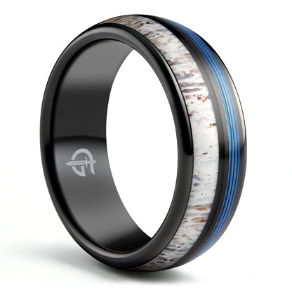 Domed black tungsten ring with blue fishing line and brown-patterned pale deer antler in separate grooves