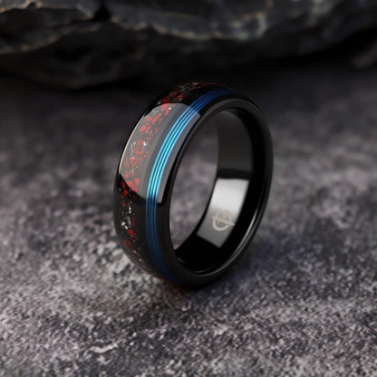 Polished black tungsten ring with fine blue fishing line beside red dinosaur bone and silver-gray meteorite fragments