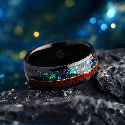 Polished black tungsten ring with gold-colored guitar string between red dinosaur bone and mixed meteorite and blue-green opal