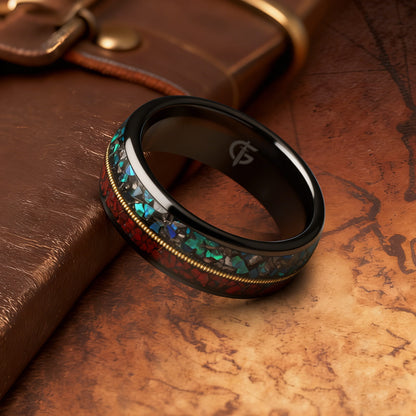 Polished black tungsten ring with gold-colored guitar string between red dinosaur bone and mixed meteorite and blue-green opal
